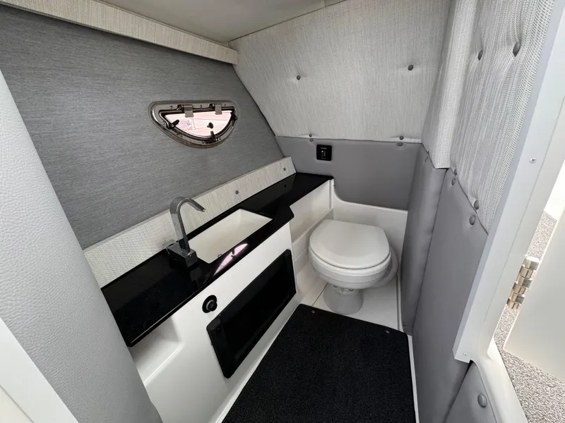 Slide: The Image of 2022 Cobalt R8 boat interior bathroom with sink, toilet, and modern design. - 12