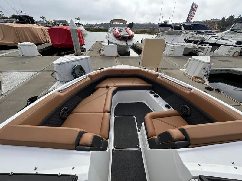 Slide: The Image of 2022 Cobalt R8 boat with tan seating at a marina dock. - 14