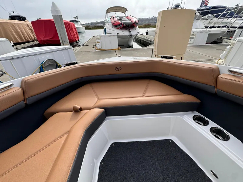 Slide: The Image of 2022 Cobalt R8 boat interior with tan seating at marina. - 16