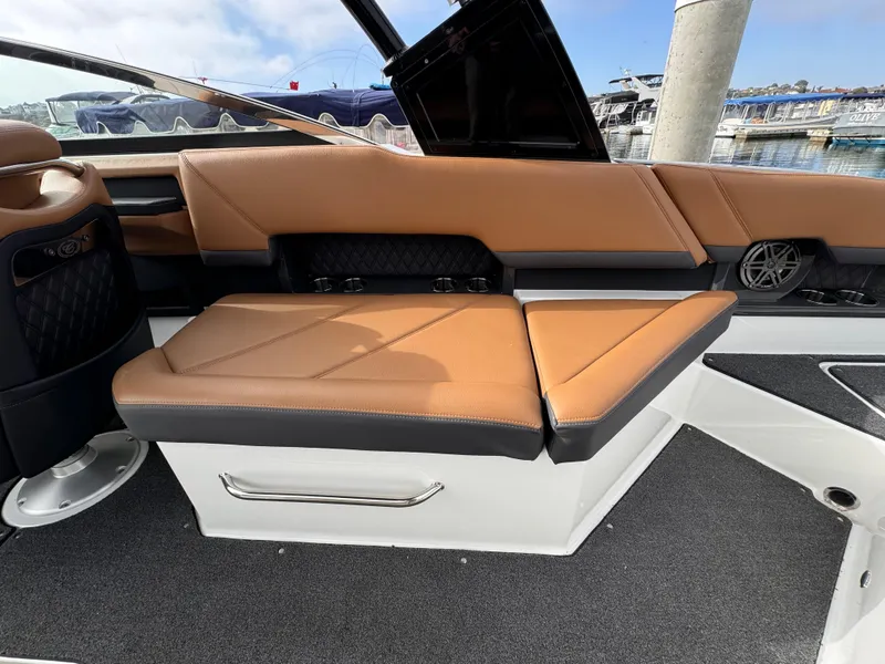 Slide: The Image of 2022 Cobalt R8 boat interior with tan leather seating and black accents. - 6