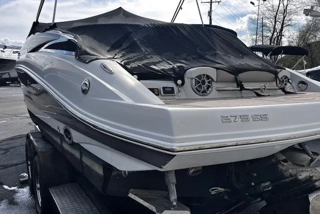 Slide: The Image of 2018 Crownline 275 SS boat with cover, rear view on trailer. - 16