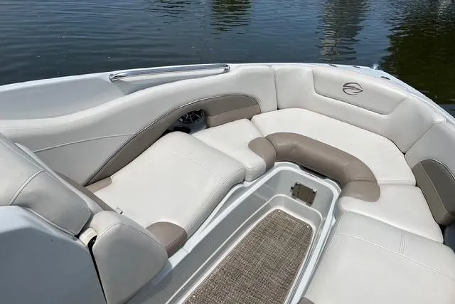 Slide: The Image of 2018 Crownline 275 SS boat interior with plush seating and water view. - 4