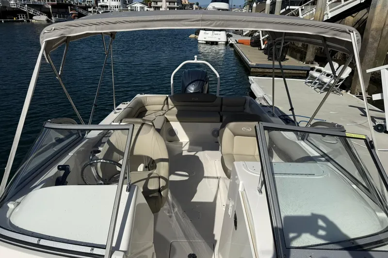 Slide: The Image of 2023 Key West 239 DFS boat docked, featuring spacious seating and canopy. - 16