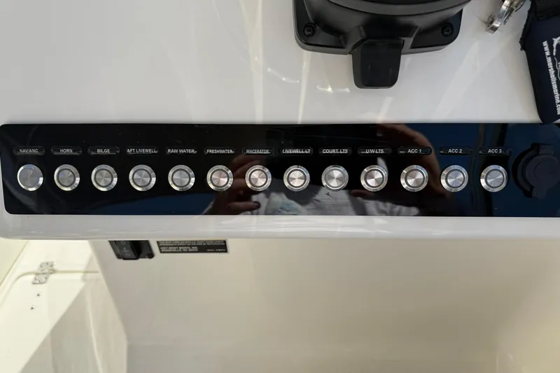 Slide: The Image of Control panel of 2023 Key West 239 DFS boat with labeled switches. - 21
