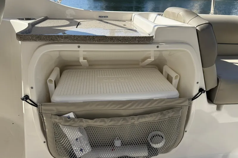 Slide: The Image of 2023 Key West 239 DFS boat interior with storage compartment and cooler. - 24