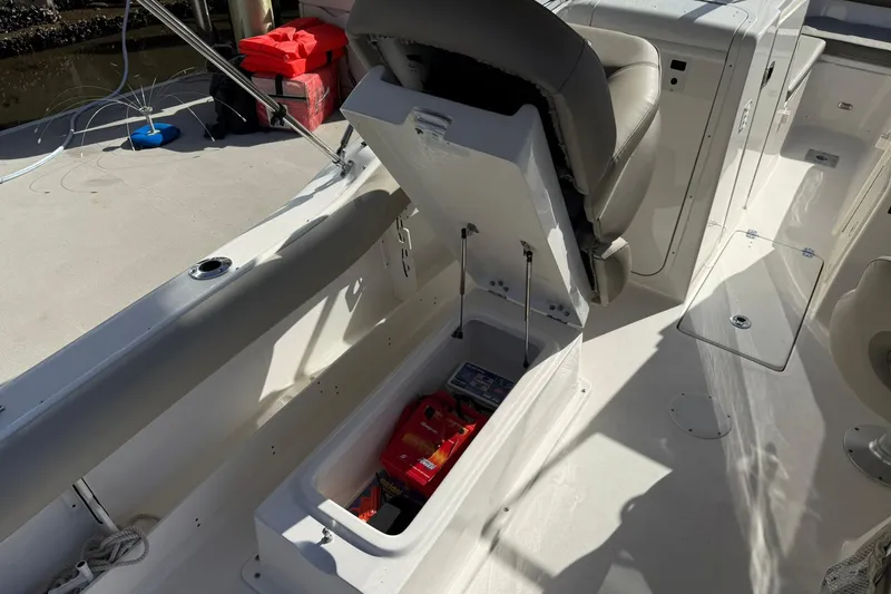 Slide: The Image of 2023 Key West 239 DFS boat interior with open storage compartment and seat. - 27