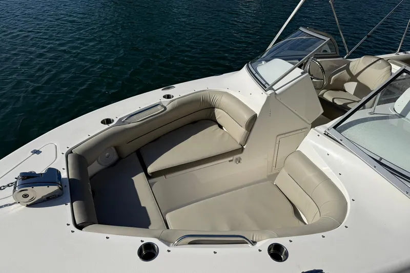 Slide: The Image of 2023 Key West 239 DFS boat interior with beige seating and open water view. - 9