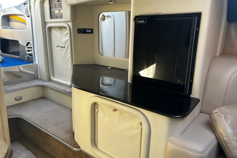 Slide: The Image of 2008 Nor-Tech 4300V boat interior with sleek black countertop and beige upholstery. - 5