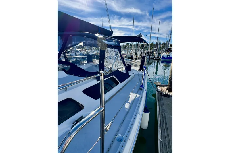 Slide: The Image of 2005 Catalina 42 MkII sailboat docked at marina under blue sky. - 13