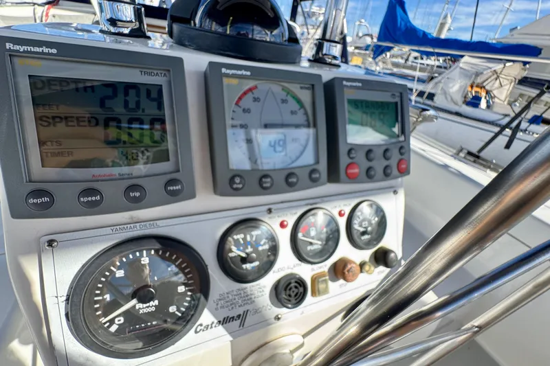 Slide: The Image of Cockpit instruments of a 2005 Catalina 42 MkII sailboat, featuring Raymarine displays. - 14