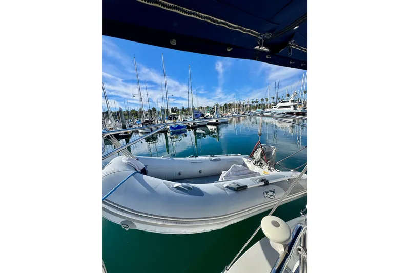 Slide: The Image of Sailboats docked at marina, featuring a 2005 Catalina 42 MkII under clear blue skies. - 18