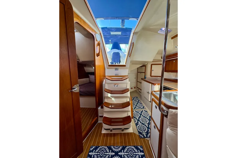 Slide: The Image of Interior of 2005 Catalina 42 MkII sailboat with wooden finishes and blue accents. - 19