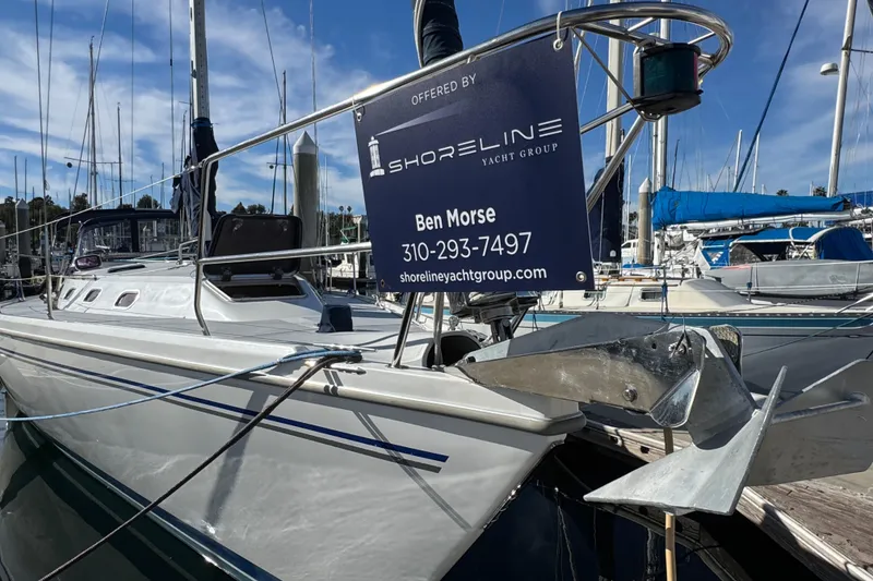 Slide: The Image of Catalina 42 MkII yacht, 2005 model, docked with Shoreline Yacht Group sign. - 2