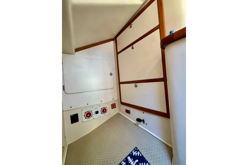Slide: The Image of Interior of 2005 Catalina 42 MkII sailboat with storage compartments and control panels. - 21