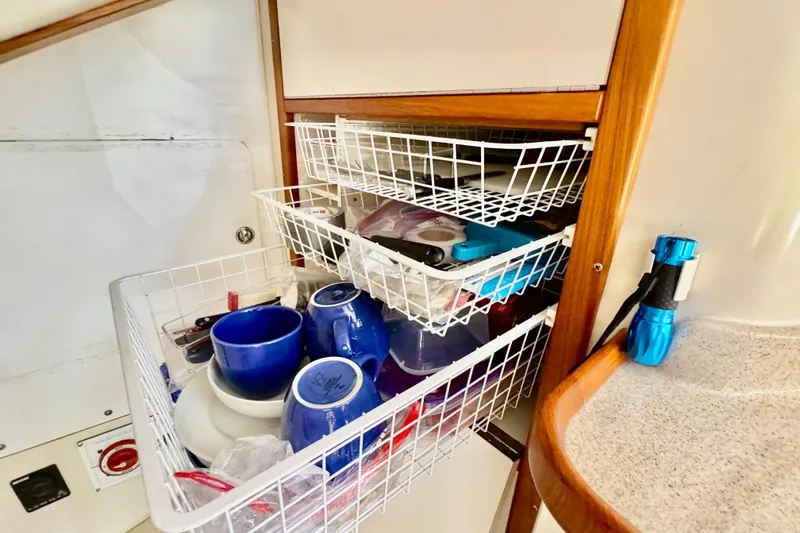 Slide: The Image of Interior of 2005 Catalina 42 MkII with organized kitchen storage and blue flashlight. - 22