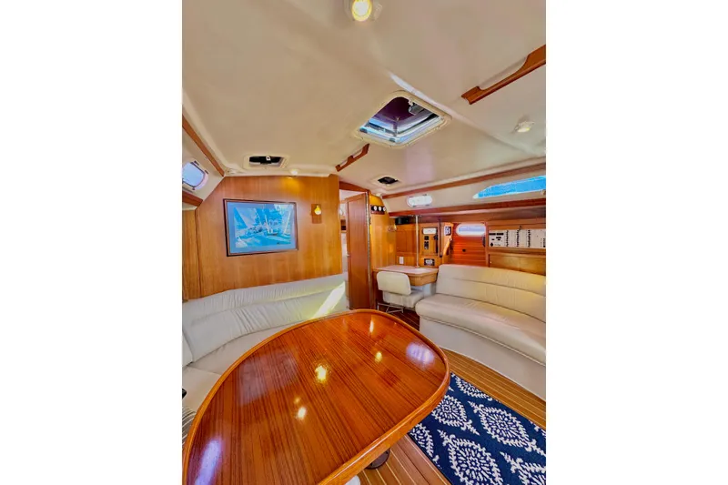 Slide: The Image of Luxurious interior of 2005 Catalina 42 MkII sailboat with elegant wood finish and seating. - 25