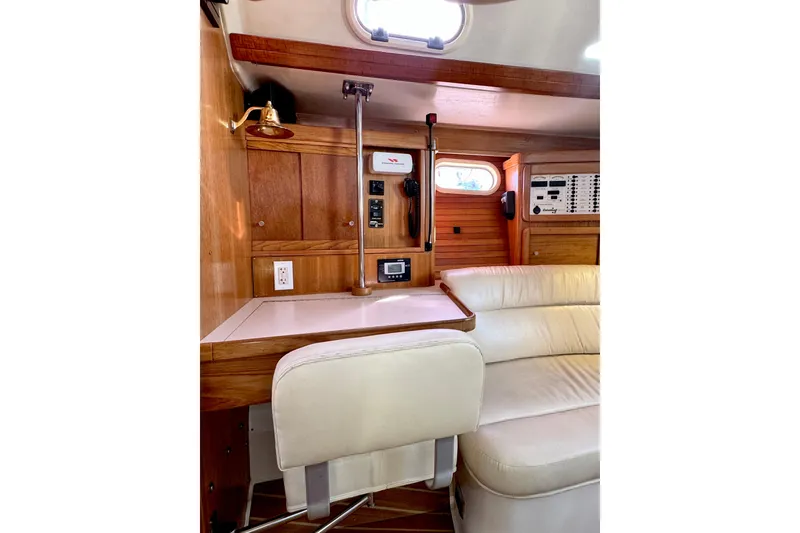 Slide: The Image of Interior of 2005 Catalina 42 MkII yacht with wood paneling and cream seating. - 26
