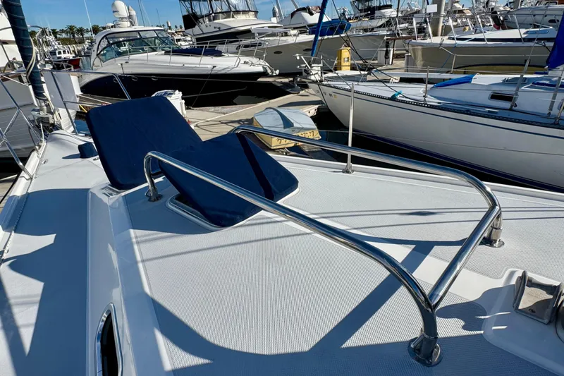 Slide: The Image of 2005 Catalina 42 MkII sailboat deck with blue cushions and stainless steel railings. - 3