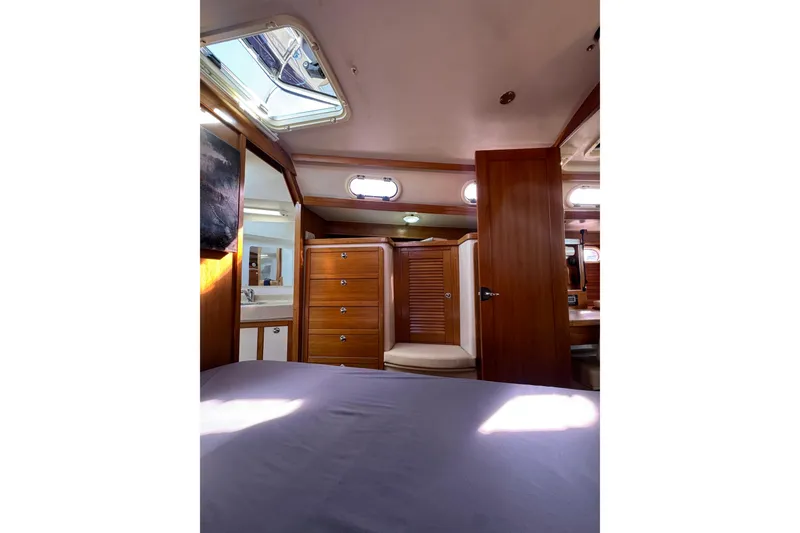 Slide: The Image of Interior of 2005 Catalina 42 MkII yacht, featuring wood cabinetry and natural light. - 32