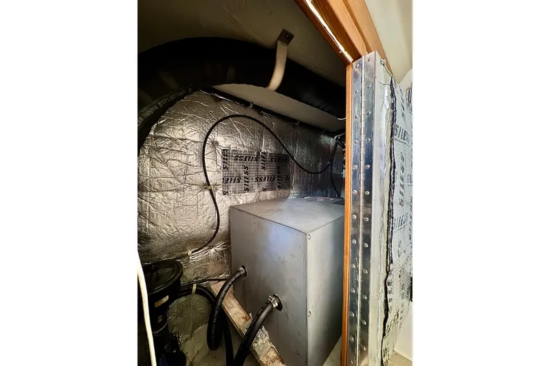 Slide: The Image of Engine compartment of a 2005 Catalina 42 MkII sailboat, featuring insulated walls and wiring. - 35