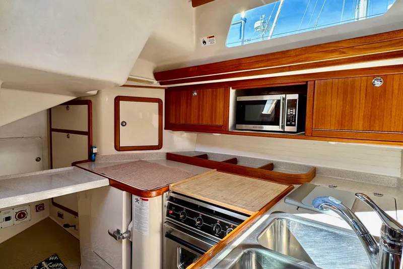 Slide: The Image of Interior of 2005 Catalina 42 MkII yacht kitchen with wood cabinets and modern appliances. - 37