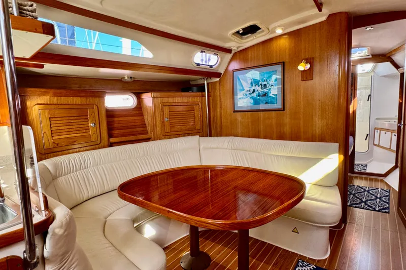 Slide: The Image of Luxurious 2005 Catalina 42 MkII yacht interior with elegant wood finish and cozy seating area. - 38