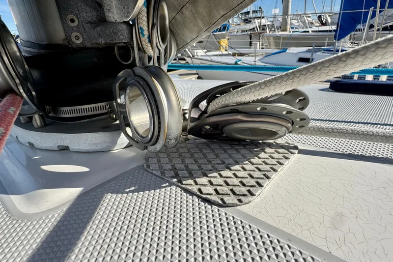 Slide: The Image of Close-up of Catalina 42 MkII sailboat deck rigging, showcasing pulleys and ropes. - 4