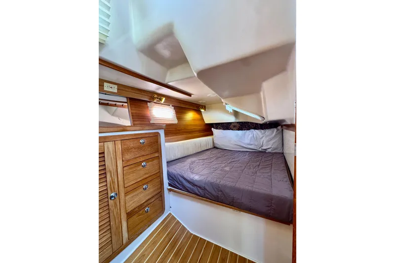 Slide: The Image of Cozy cabin interior of 2005 Catalina 42 MkII sailboat with wooden cabinetry and comfortable bedding. - 41