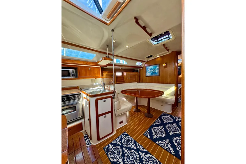 Slide: The Image of Luxurious interior of 2005 Catalina 42 MkII sailboat with wood finishes and cozy seating. - 42