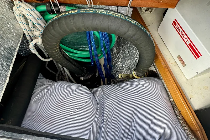 Slide: The Image of 2005 Catalina 42 MkII engine compartment with hoses and Sea Frost refrigeration unit. - 45