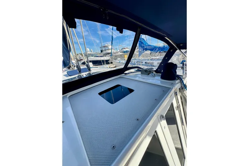 Slide: The Image of 2005 Catalina 42 MkII sailboat cockpit with marina view, featuring sleek design and modern amenities. - 51