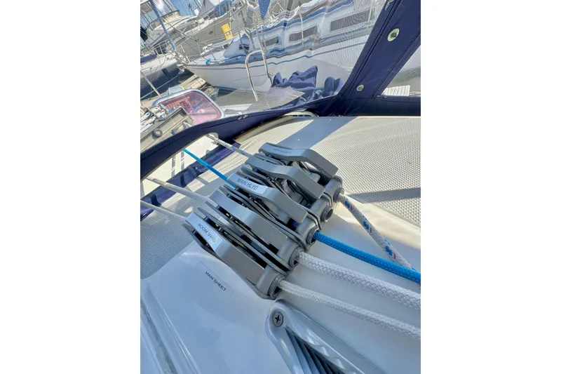 Slide: The Image of Rope clutches on a 2005 Catalina 42 MkII sailboat deck, with marina background. - 52