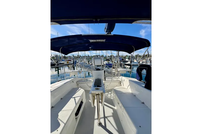 Slide: The Image of 2005 Catalina 42 MkII sailboat cockpit with blue canopy, docked in marina. - 6