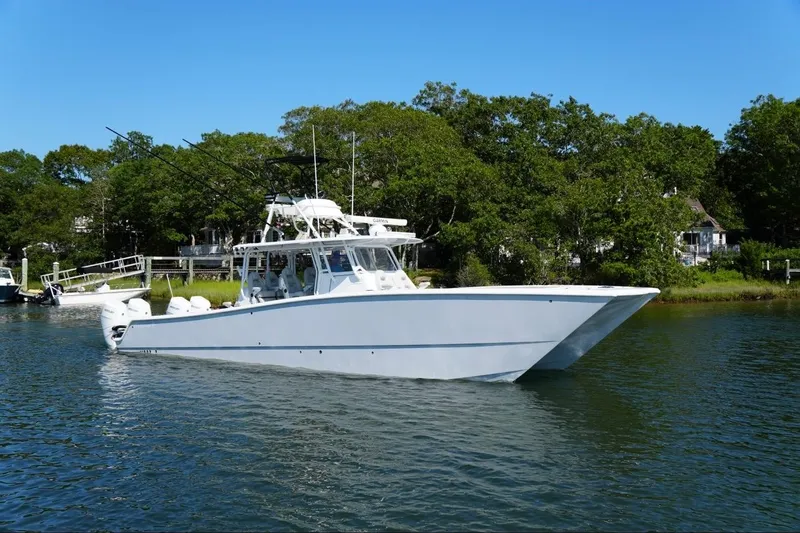 Slide: The Image of 2025 Freeman 42LR boat on water, featuring dual outboard engines and spacious deck. - 0