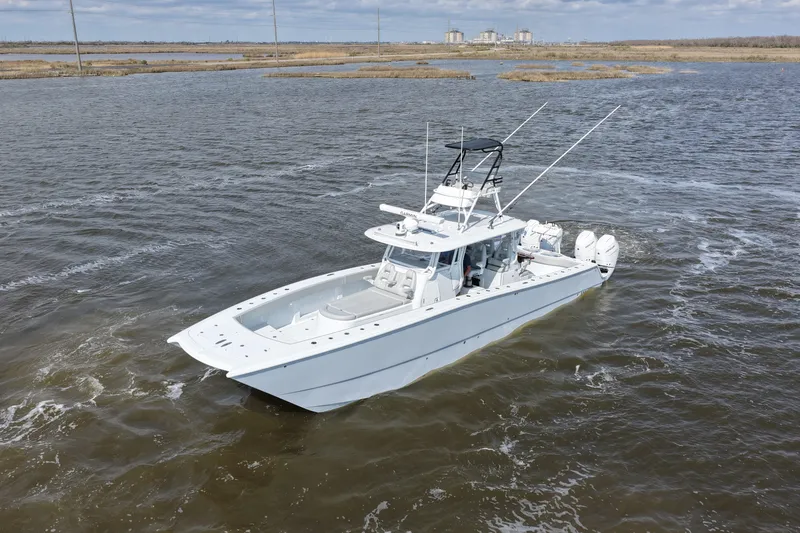 Slide: The Image of 2025 Freeman 42LR boat cruising on open water, showcasing sleek design and powerful engines. - 11