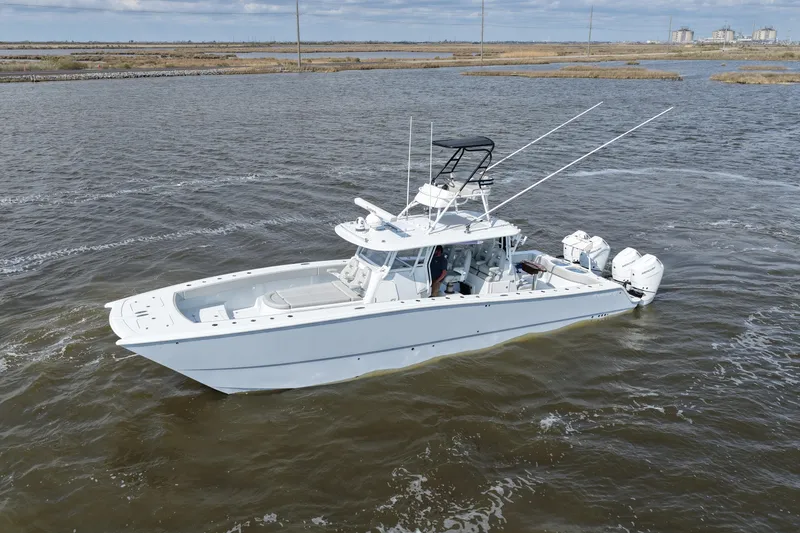 Slide: The Image of 2025 Freeman 42LR boat cruising on open water, showcasing sleek design and powerful engines. - 12