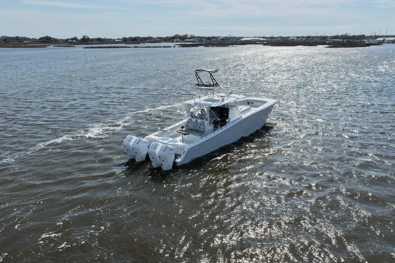 Slide: The Image of 2025 Freeman 42LR boat cruising on a sunny day in open waters. - 17