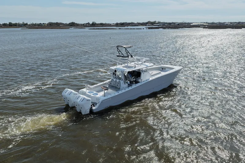 Slide: The Image of 2025 Freeman 42LR boat cruising on a sunny day in open waters. - 18