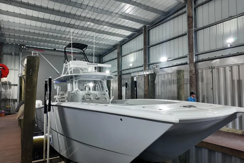 Slide: The Image of 2025 Freeman 42LR boat docked in a modern indoor marina. - 26