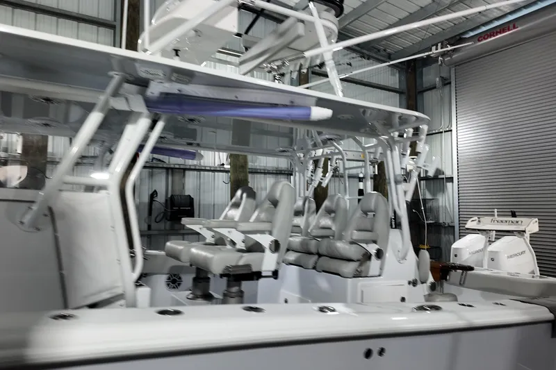 Slide: The Image of 2025 Freeman 42LR boat interior with seating and Mercury engines in a garage. - 27