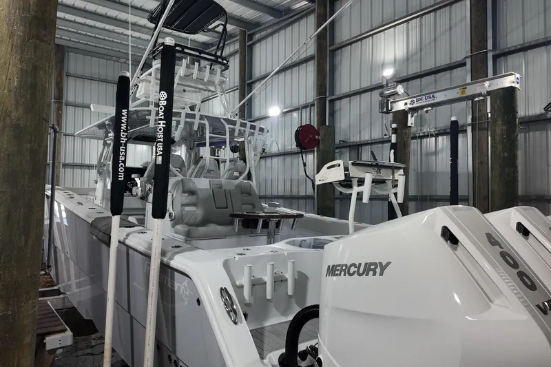 Slide: The Image of 2025 Freeman 42LR boat with Mercury engines in a covered dock. - 29