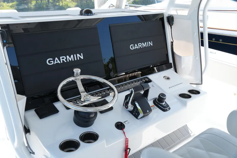 Slide: The Image of Helm of 2025 Freeman 42 LR boat with dual Garmin displays and modern controls. - 35