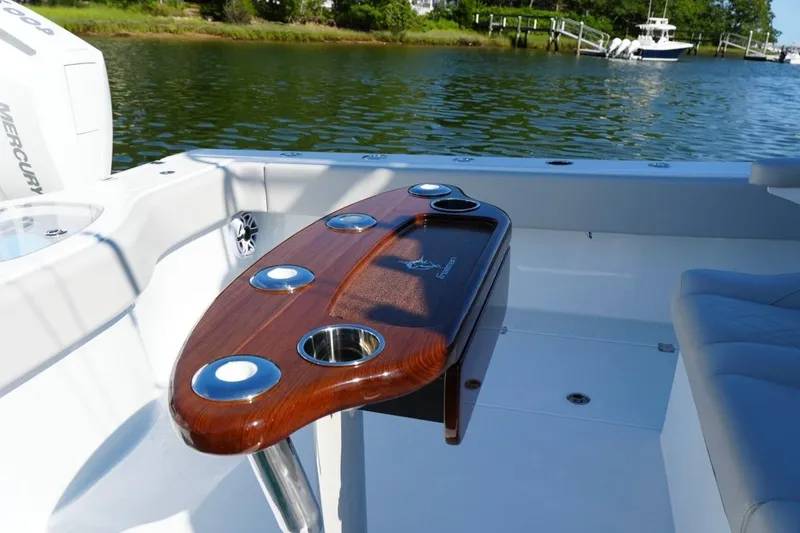 Slide: The Image of Luxurious 2025 Freeman 42 LR boat interior with elegant wooden table and cup holders. - 38
