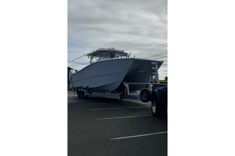 Slide: The Image of 2025 Freeman 42LR boat on trailer in parking lot, overcast sky. - 40