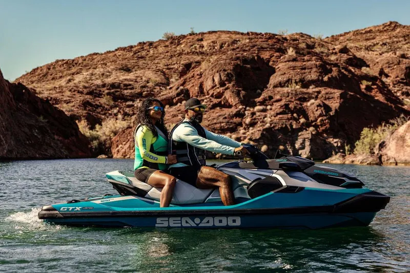 Slide: The Image of Manufacturer Provided Image: 2026 Sea-Doo GTX Limited 325 on scenic water with rocky backdrop. - 5