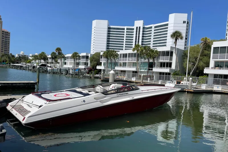 The Image of 2007 Fountain 42 Lightning boat docked in a marina with modern buildings in the background. - 1