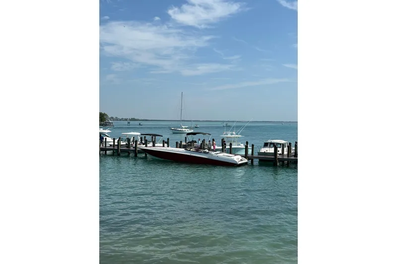 Slide: The Image of 2007 Fountain 42 Lightning boat docked at a marina on a sunny day. - 5