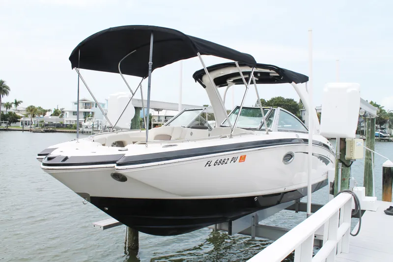 Slide: The Image of 2015 Chaparral Sunesta 264 boat docked with black canopy, in a marina setting. - 29