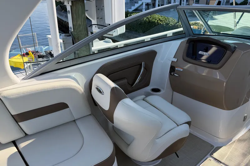 Slide: The Image of Interior of 2015 Chaparrall 264 Sunesta boat with white and brown seating. - 17
