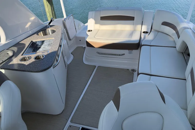 Slide: The Image of 2015 Chaparrall 264 Sunesta boat interior with seating and kitchenette. - 19